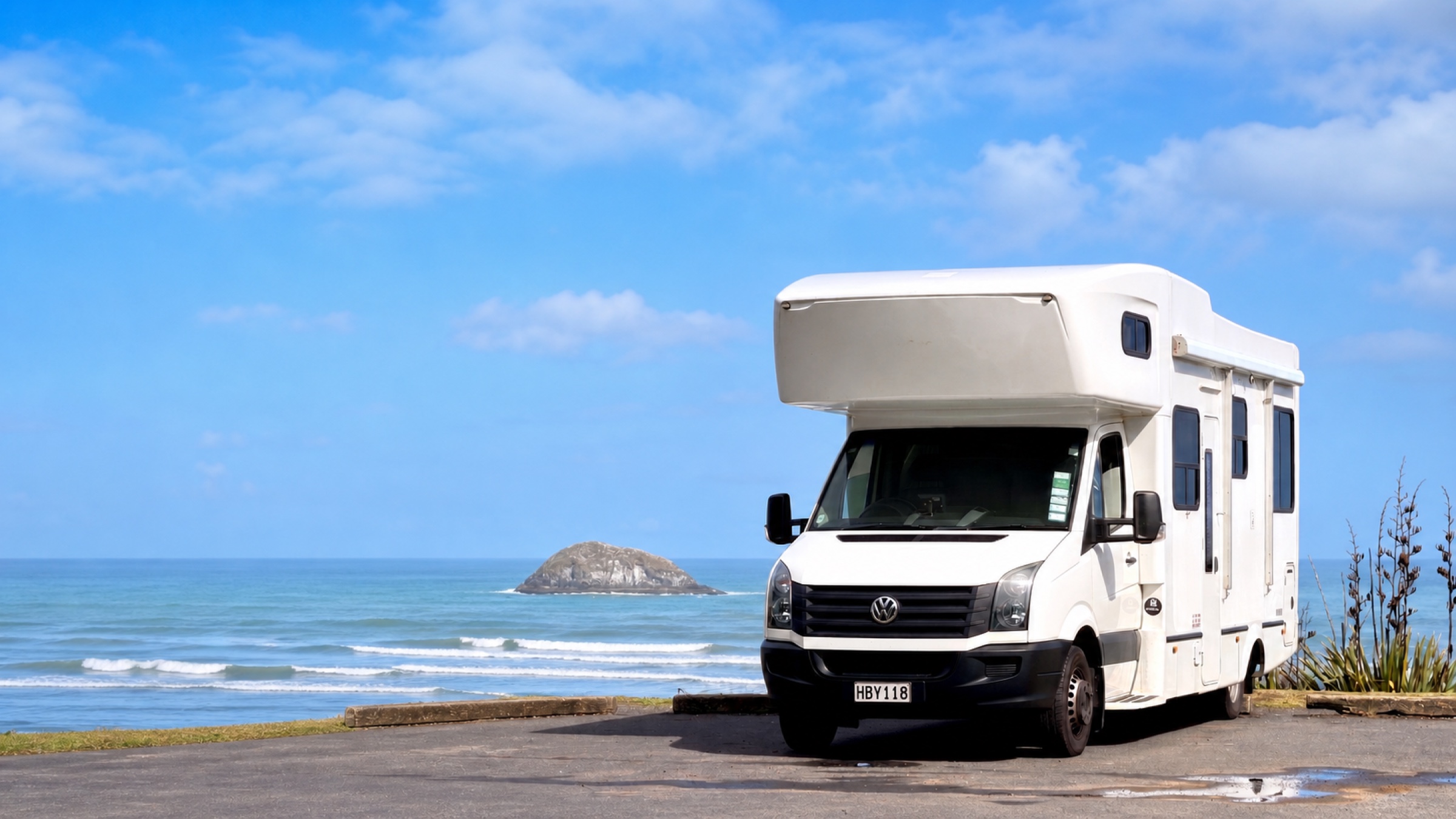 The real Hey Buddy motorhome parked beside the New Zealand coast