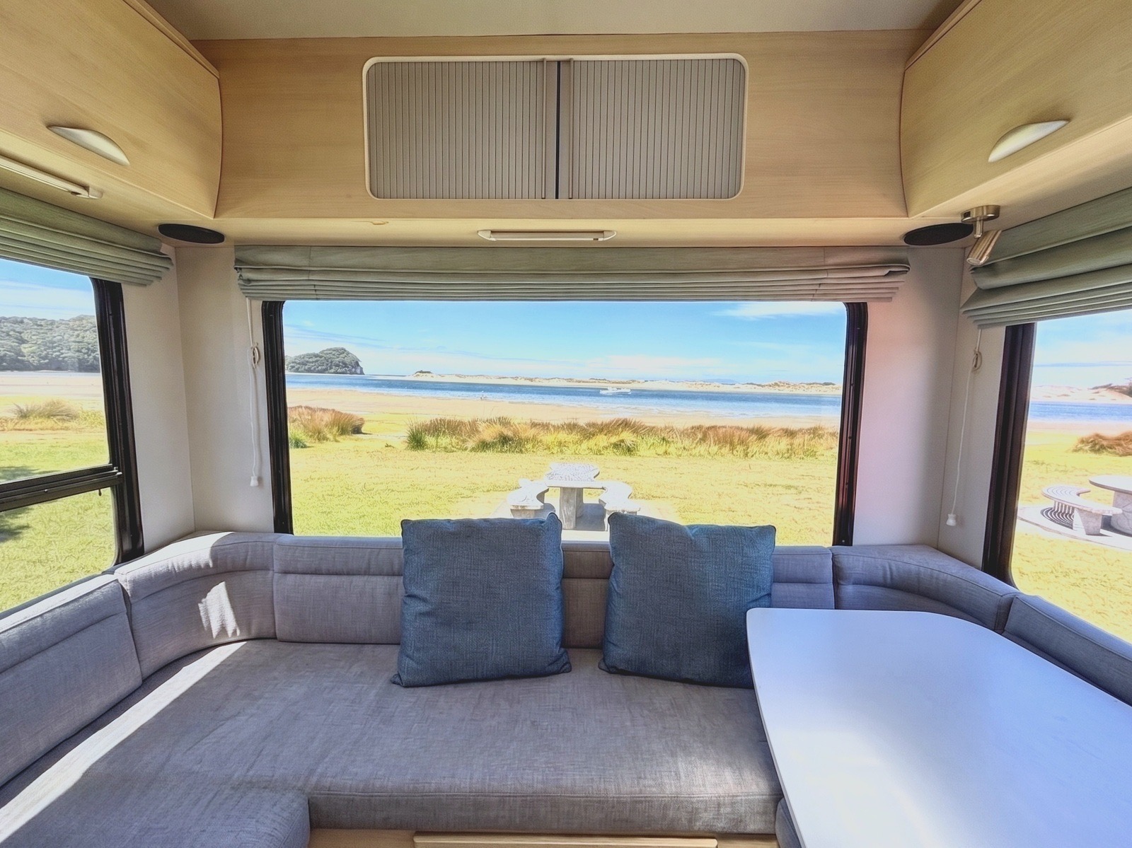 Hey Buddy rear lounge with wide windows and a coastal view